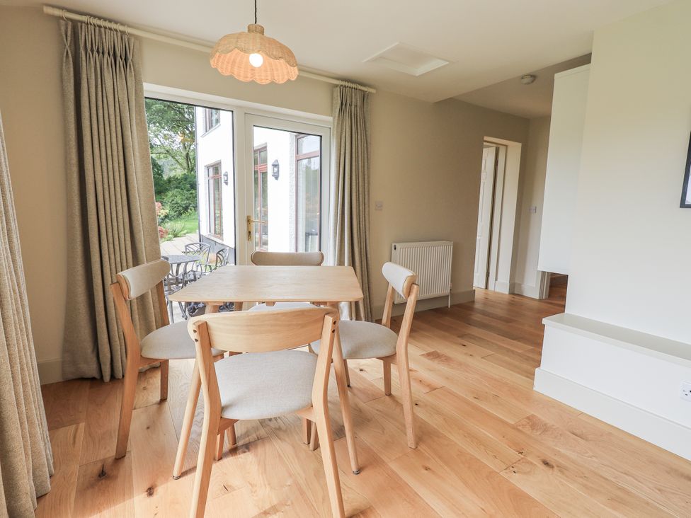 A dining room with a table and chairs at Rowanhill in Kendal