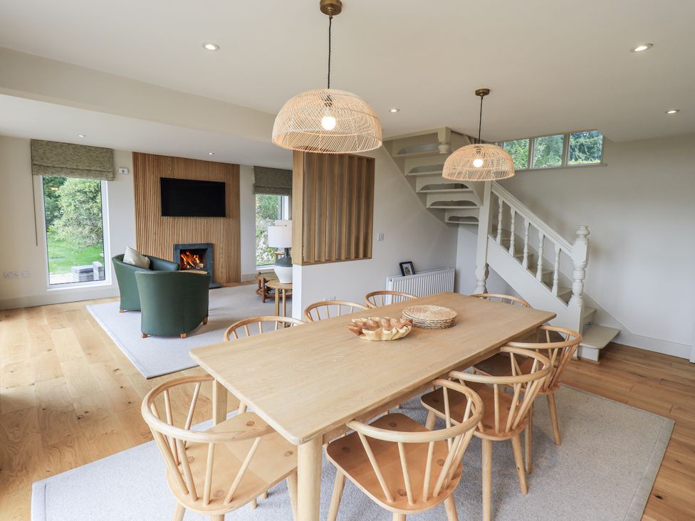 A dining room with a table and chairs at Rowanhill in Kendal