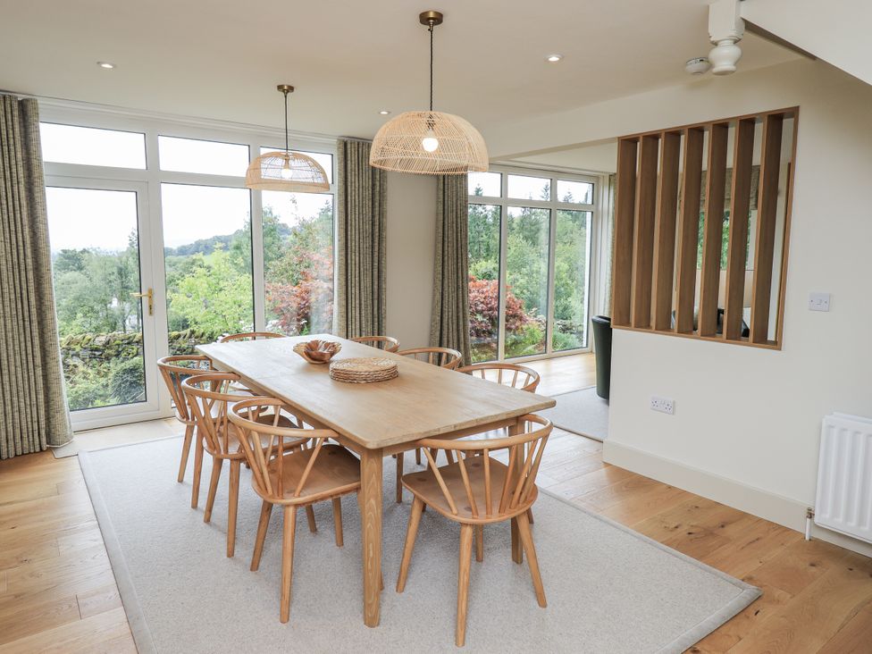 A dining room with a table and chairs at Rowanhill in Kendal