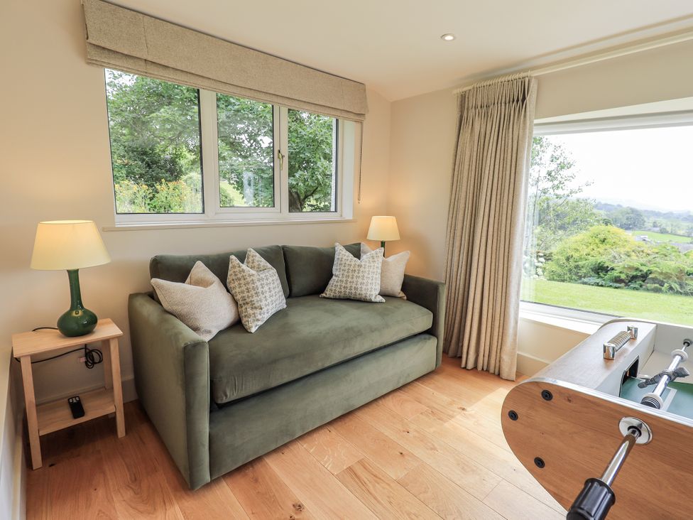 A snug with a sofa and foosball table at Rowanhill in Kendal