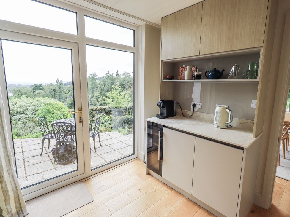 A kitchen with a view to an outdoor patio at Rowanhill in Kendal