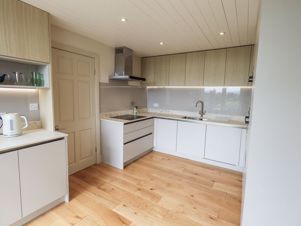 A kitchen with cabinets and a sink at Rowanhill in Kendal