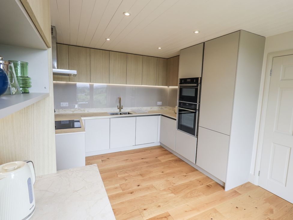 A kitchen with cabinets and appliances at Rowanhill in Kendal