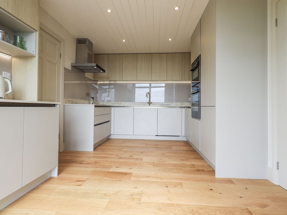 A kitchen with cabinets and appliances at Rowanhill in Kendal