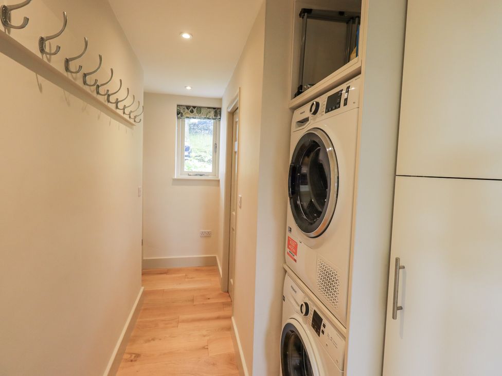 A laundry room with washing machine and tumble dryer at Rowanhill Kendal