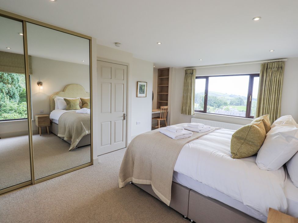 A bedroom with a bed and window at Rowanhill in Kendal