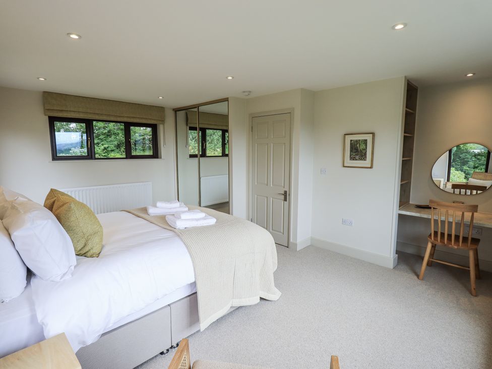 A bedroom with a bed and a desk at Rowanhill in Kendal