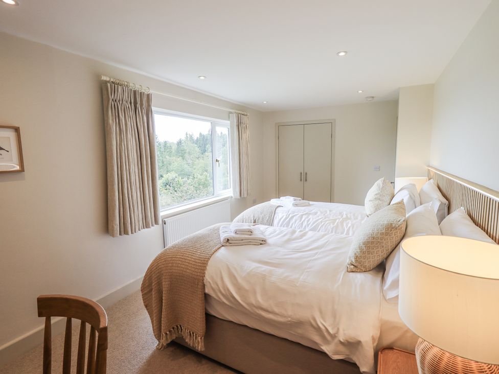 A bedroom with two beds and a window at Rowanhill in Kendal