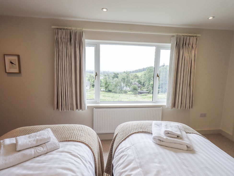 A bedroom with two beds and a view at Rowanhill in Kendal