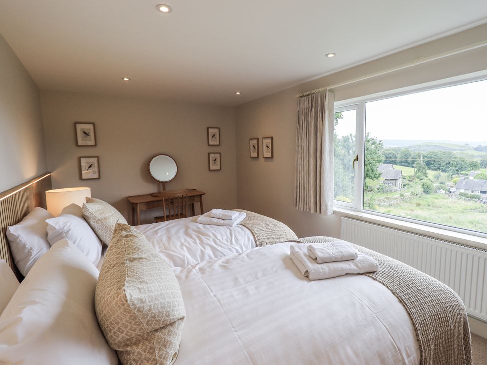 A bedroom with two beds and a window at Rowanhill in Kendal