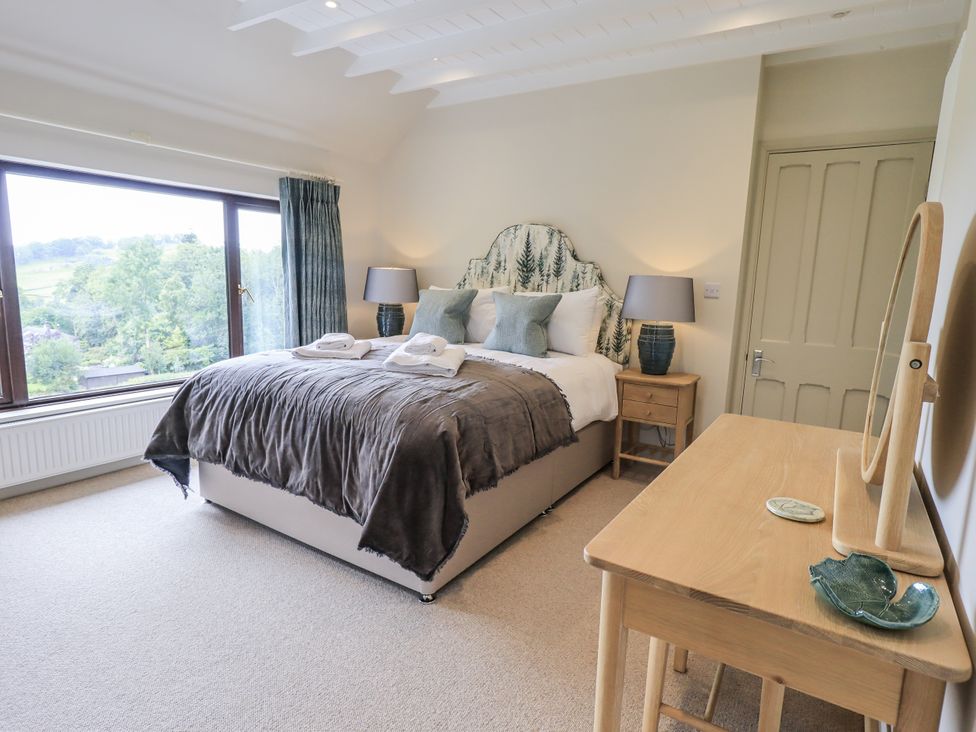A bedroom featuring a bed with pillows at Rowanhill Kendal