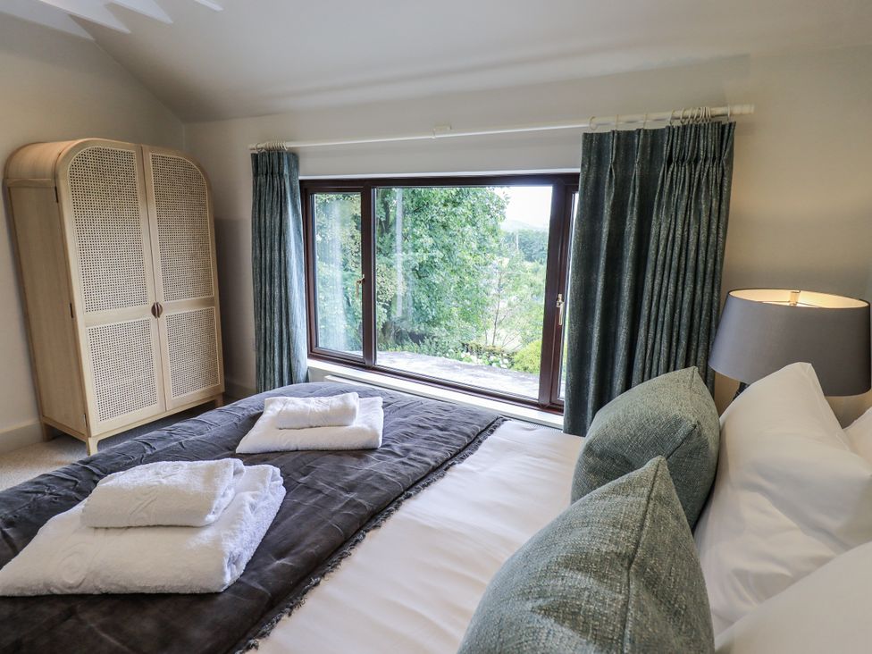 A bedroom with a bed and wardrobe at Rowanhill in Kendal