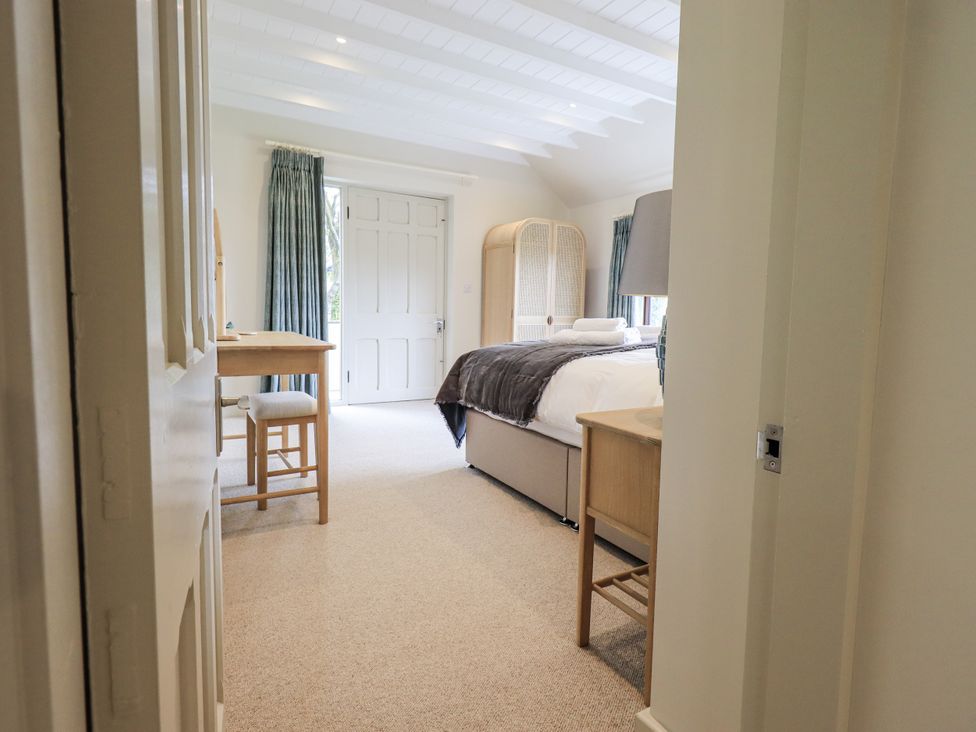 A bedroom with a bed and a small table at Rowanhill in Kendal