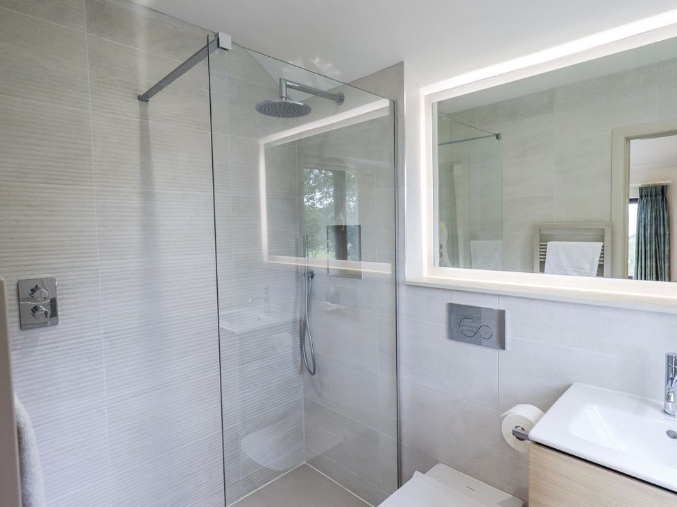 A bathroom with a shower and sink at Rowanhill in Kendal