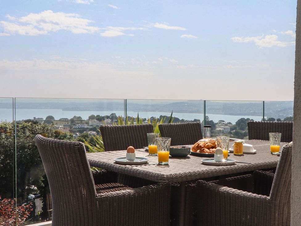 An outdoor dining area with a table set for breakfast at Seacroft in Torquay