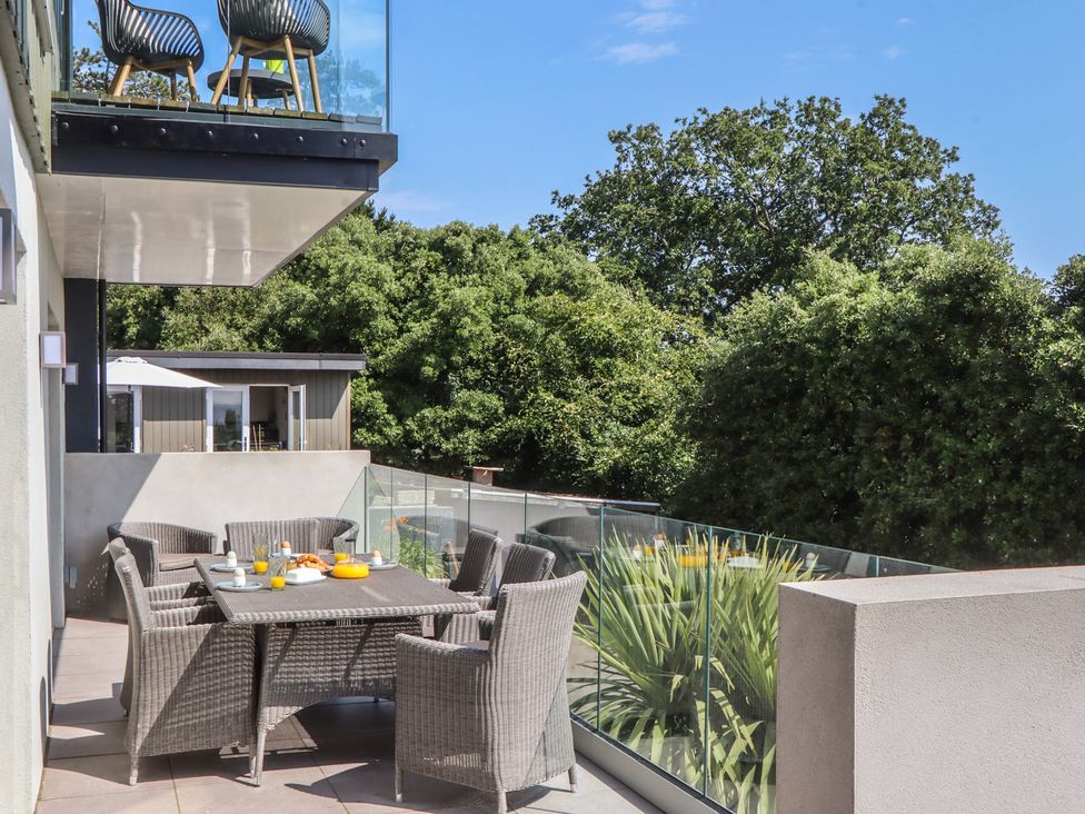 A balcony with a table and chairs at Seacroft in Torquay