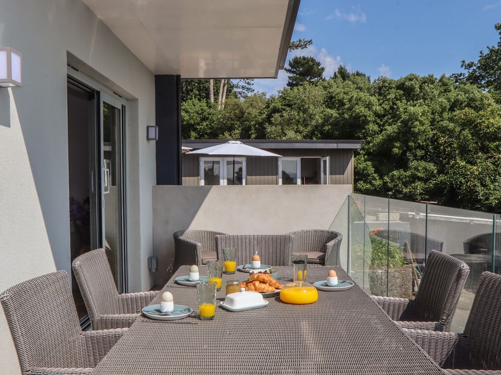 A balcony with outdoor seating and breakfast items at Seacroft in Torquay