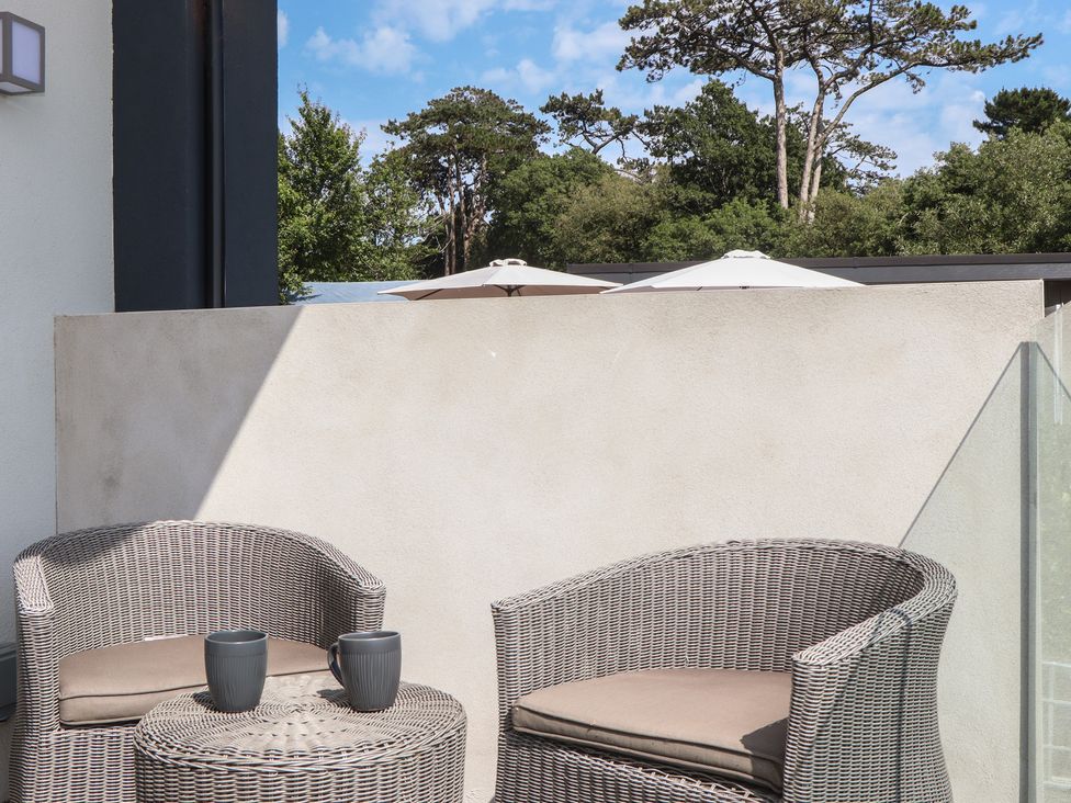 An outdoor seating area with chairs and a table at Seacroft in Torquay