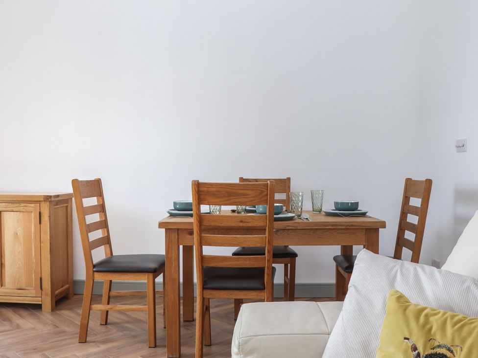 A dining room with a table and chairs at Seacroft Torquay