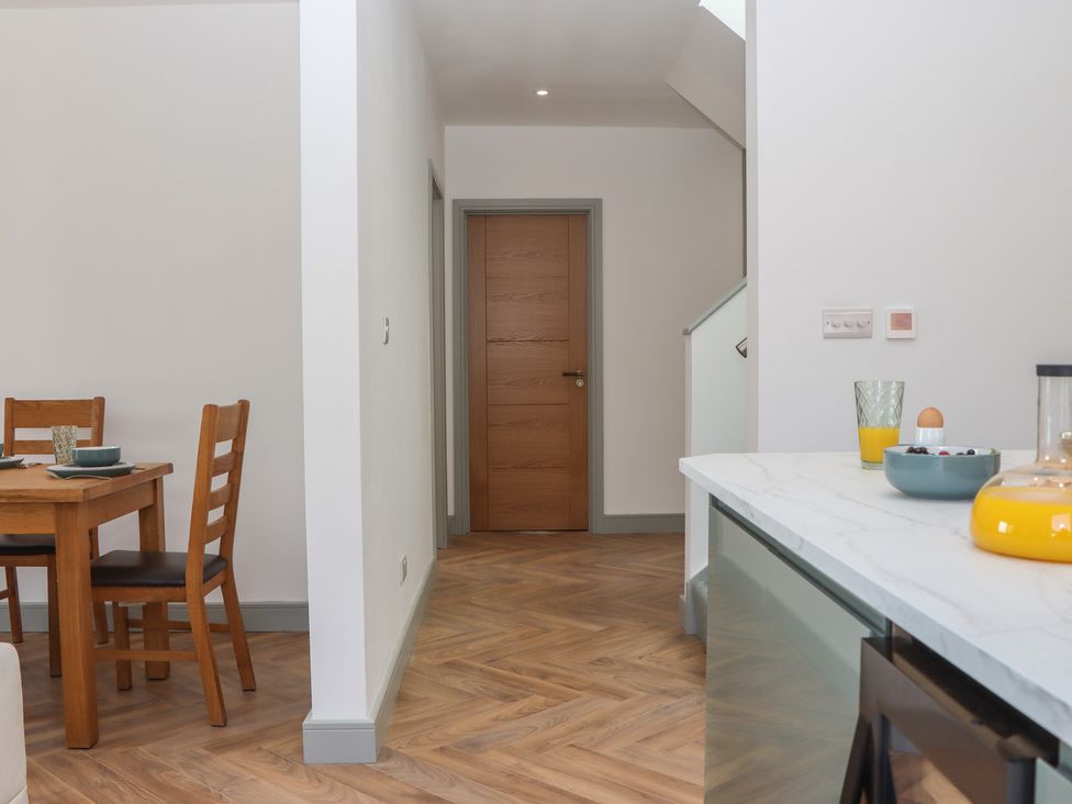 A dining room with a table and chairs at Seacroft in Torquay