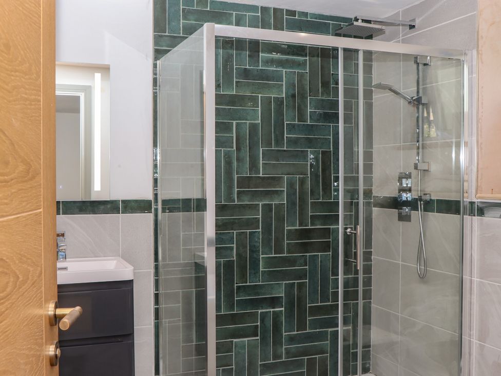 A bathroom with a shower and sink at Seacroft in Torquay