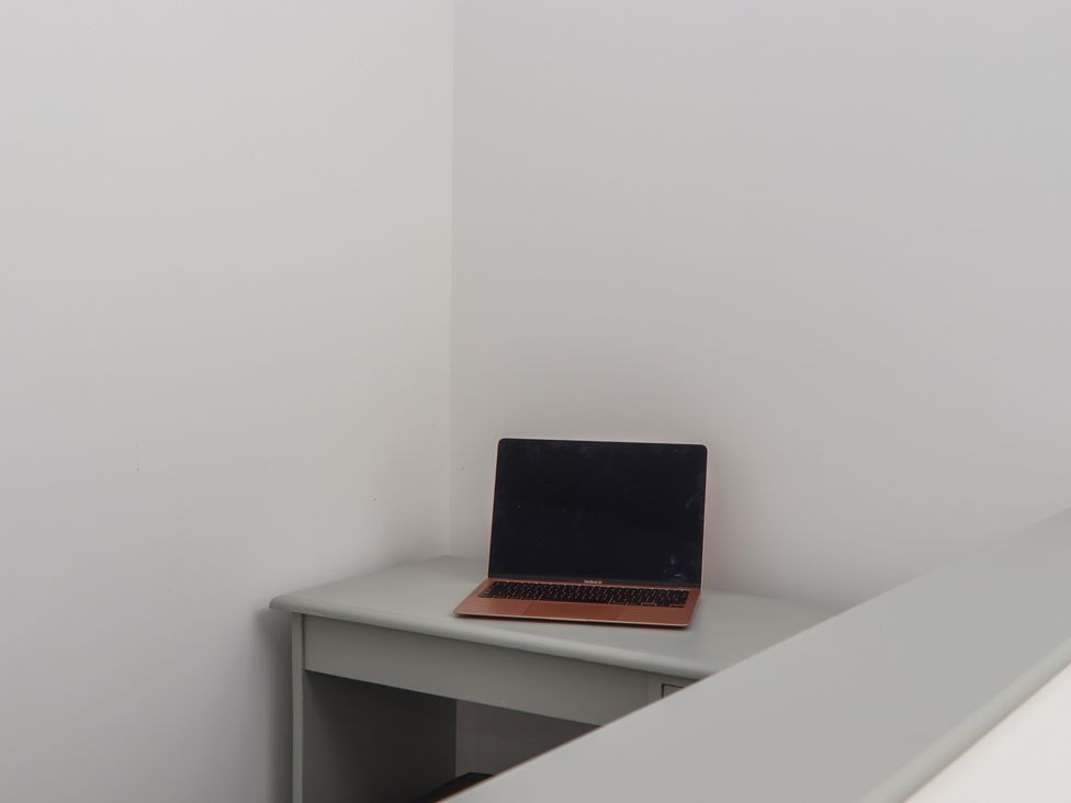A desk with a laptop in a home office at Seacroft in Torquay