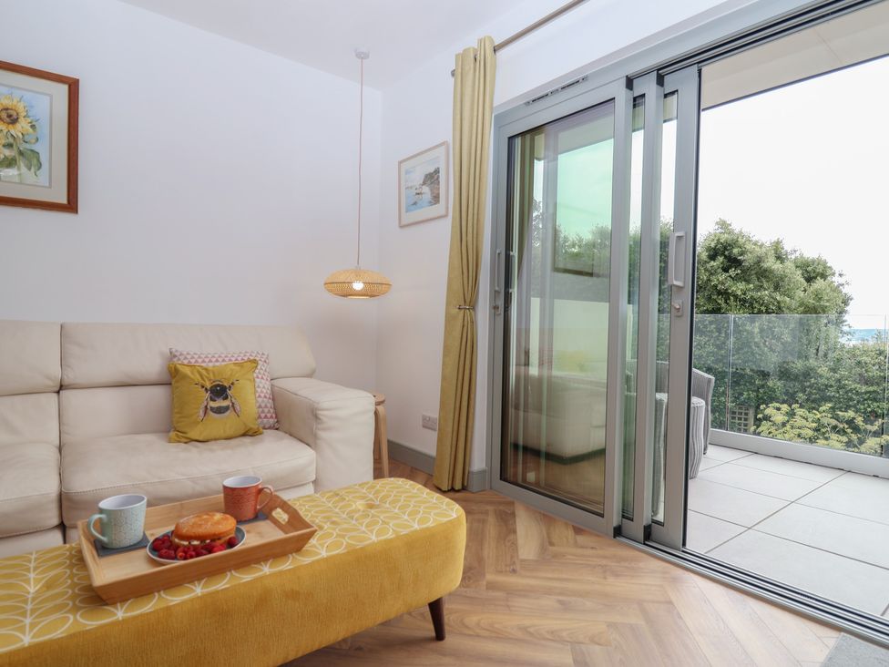 A living room with a sofa and coffee table at Seacroft in Wellswood near Torquay