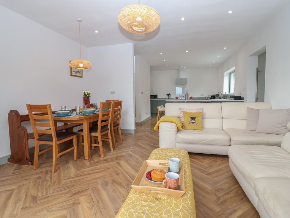 A living room with dining area and kitchen at Seacroft in Wellswood near Torquay