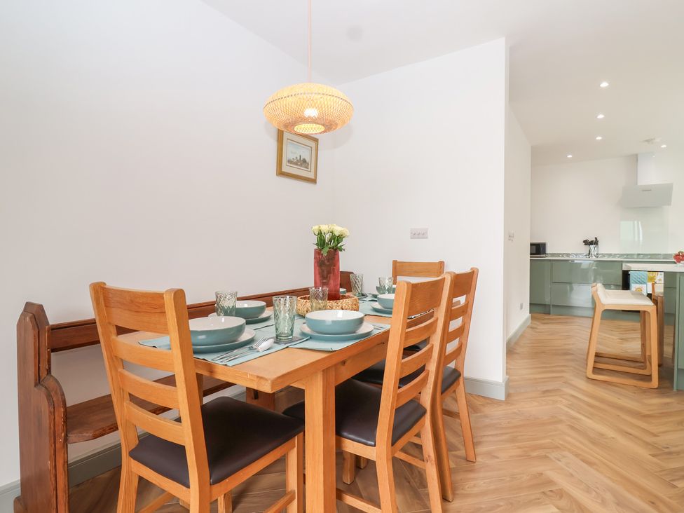 A dining room with a table set for meals at Seacroft in Wellswood near Torquay