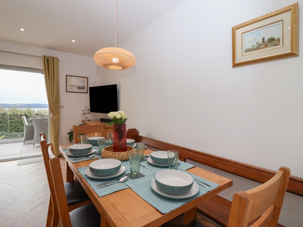 A dining room with table set for a meal at Seacroft in Wellswood near Torquay