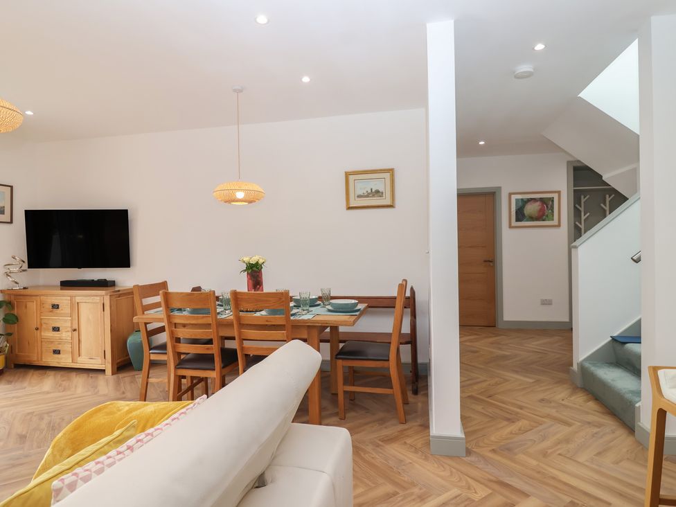 A living room with a dining area and stairs at Seacroft in Wellswood near Torquay