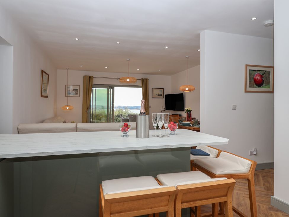 A kitchen with a breakfast bar and wine at Seacroft in Wellswood near Torquay