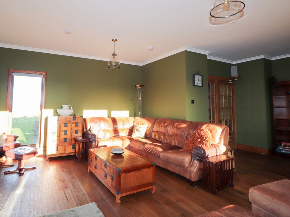 A living room with a sofa and coffee table at Northbanks House in Thurso