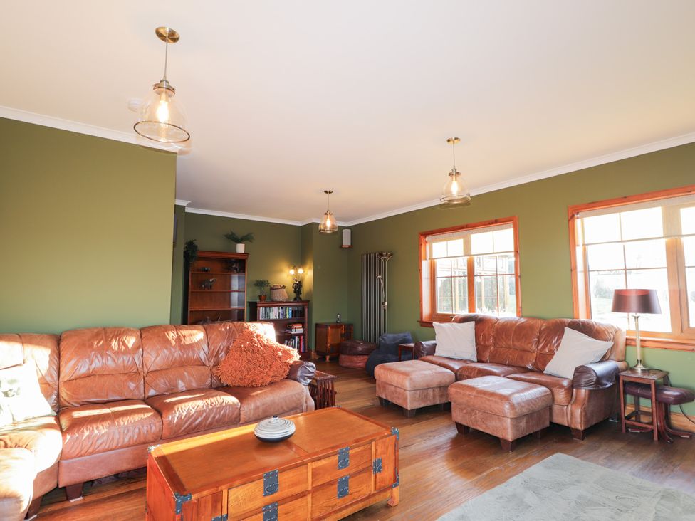 A living room with sofas and a wooden coffee table at Northbanks House Thurso