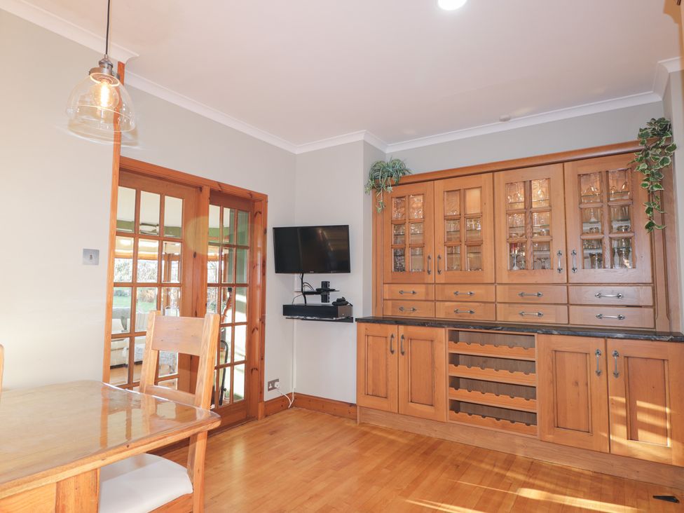 A dining room with a wooden table and chairs at Northbanks House Thurso