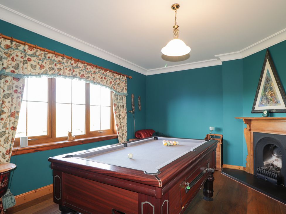 A games room with a pool table and windows at Northbanks House Thurso
