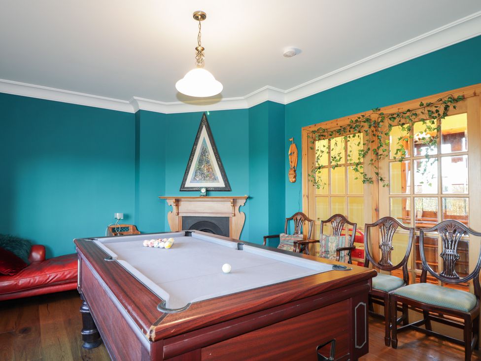 A game room with a pool table and chairs at Northbanks House in Thurso