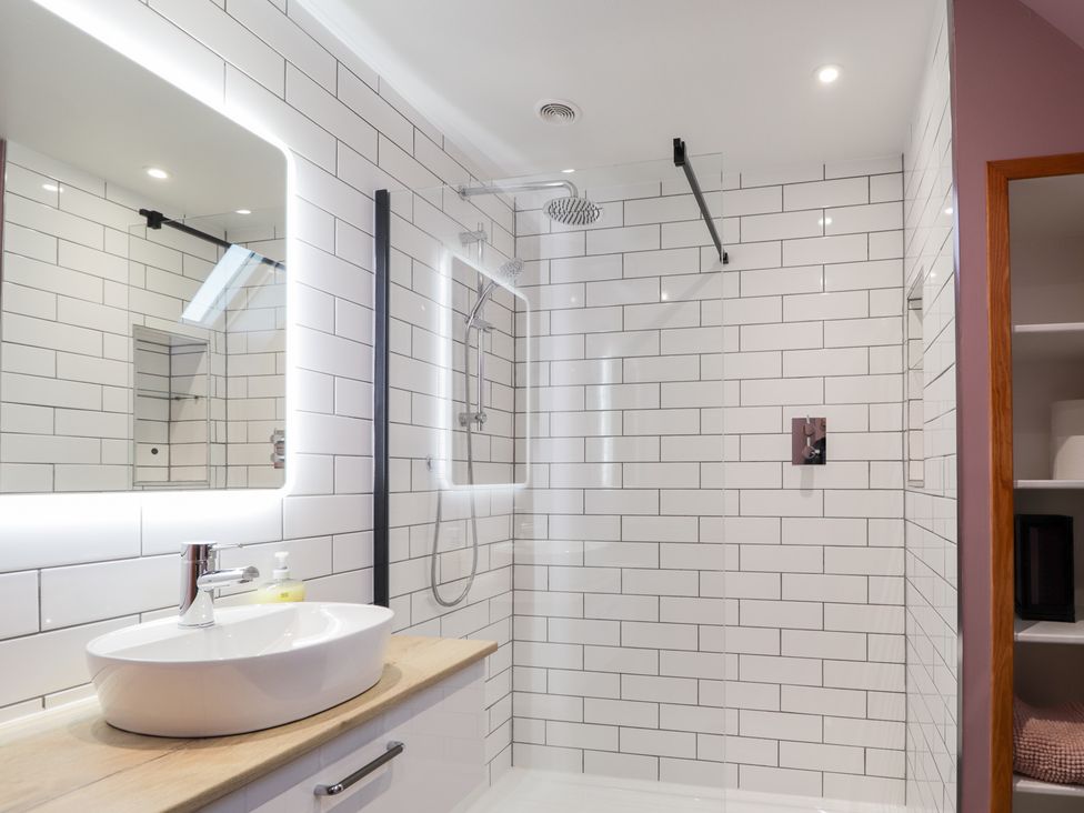 A bathroom with a shower and sink at Northbanks House in Thurso