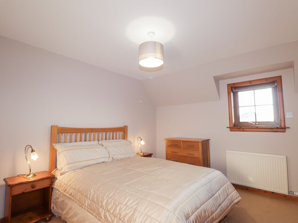 A bedroom with a bed and a dresser at Northbanks House Thurso