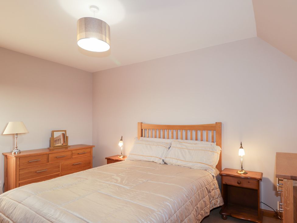 A bedroom with a bed and furniture at Northbanks House Thurso