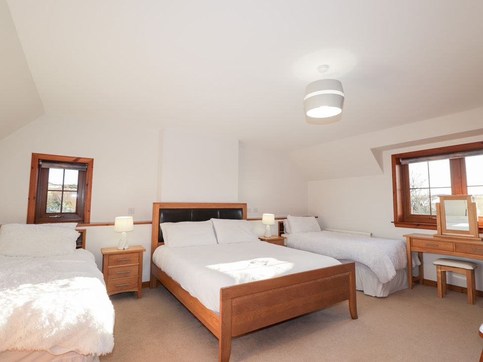 A bedroom with two beds and a desk at Northbanks House Thurso