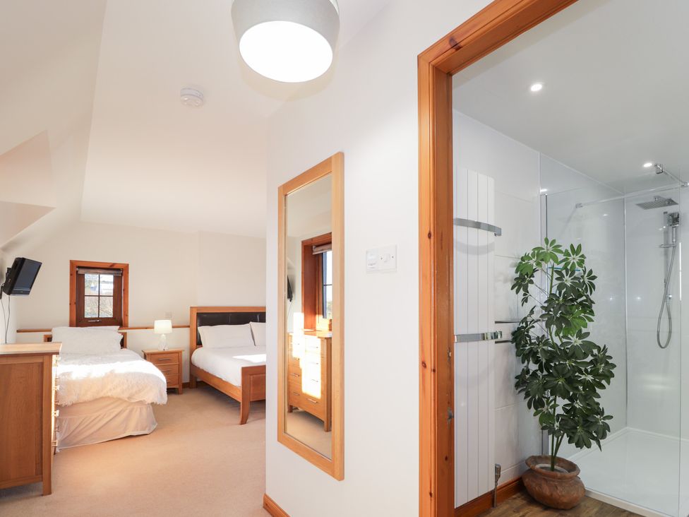 A bedroom with beds and a shower at Northbanks House Thurso