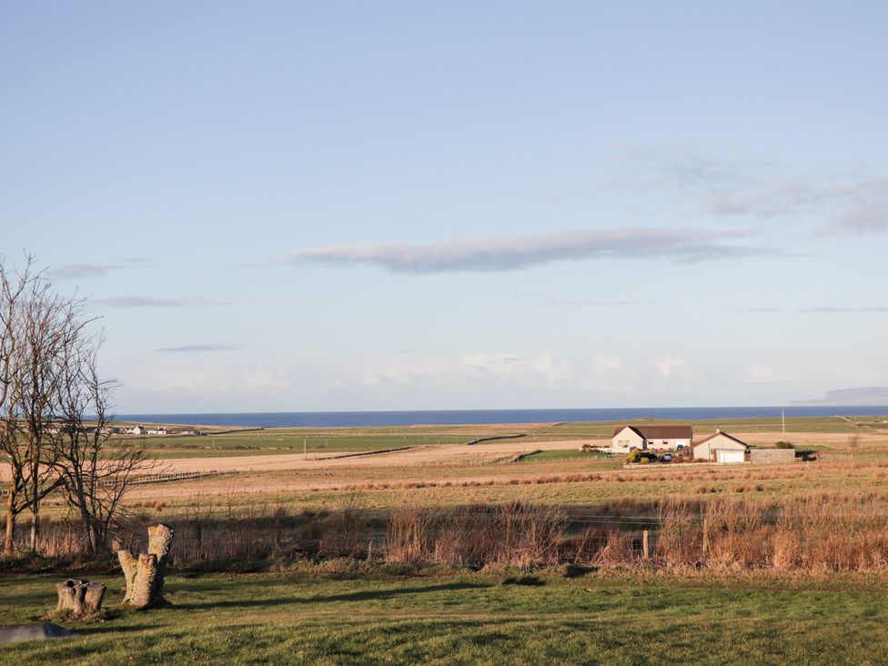 A view of farmland and ocean at Northbanks House in Thurso