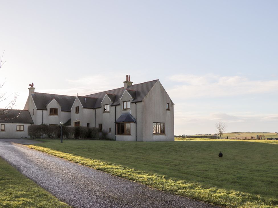 A house with a pathway and grass at Northbanks House in Thurso