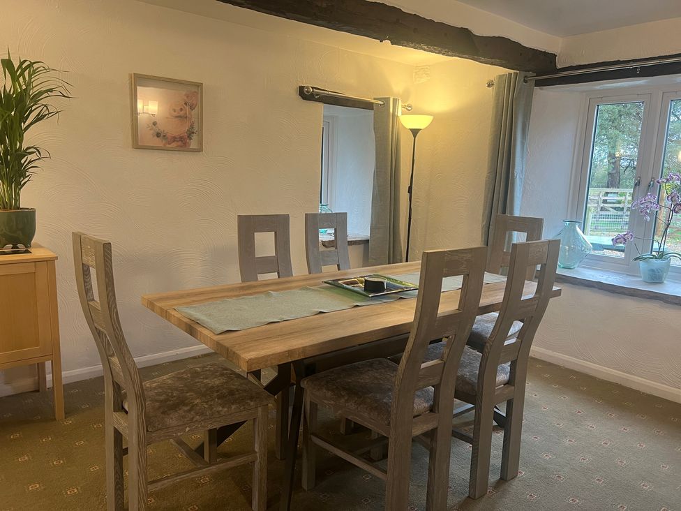 A dining room with a table and chairs at The Old Farmhouse at Brackenthwaite Farm Yealand Redmayne near Arnside