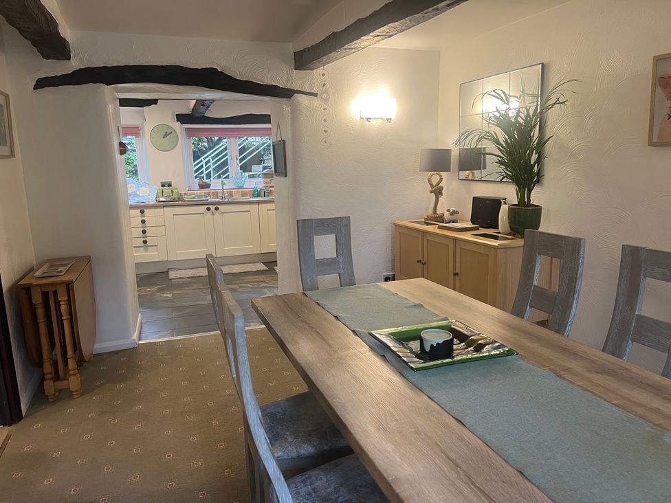 A dining room with a table and chairs at The Old Farmhouse at Brackenthwaite Farm Yealand Redmayne near Arnside