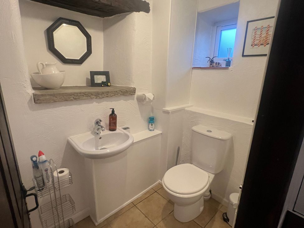 A bathroom with a toilet and sink at The Old Farmhouse at Brackenthwaite Farm Yealand Redmayne near Arnside