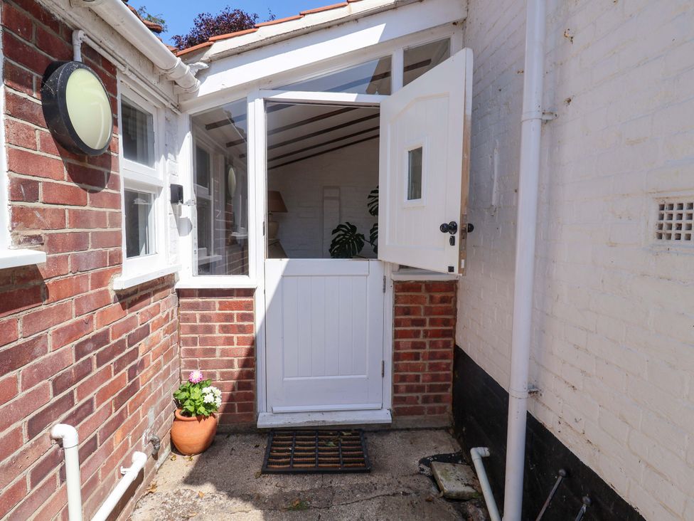 An entrance with an open door and a potted plant at Beehive in Beccles