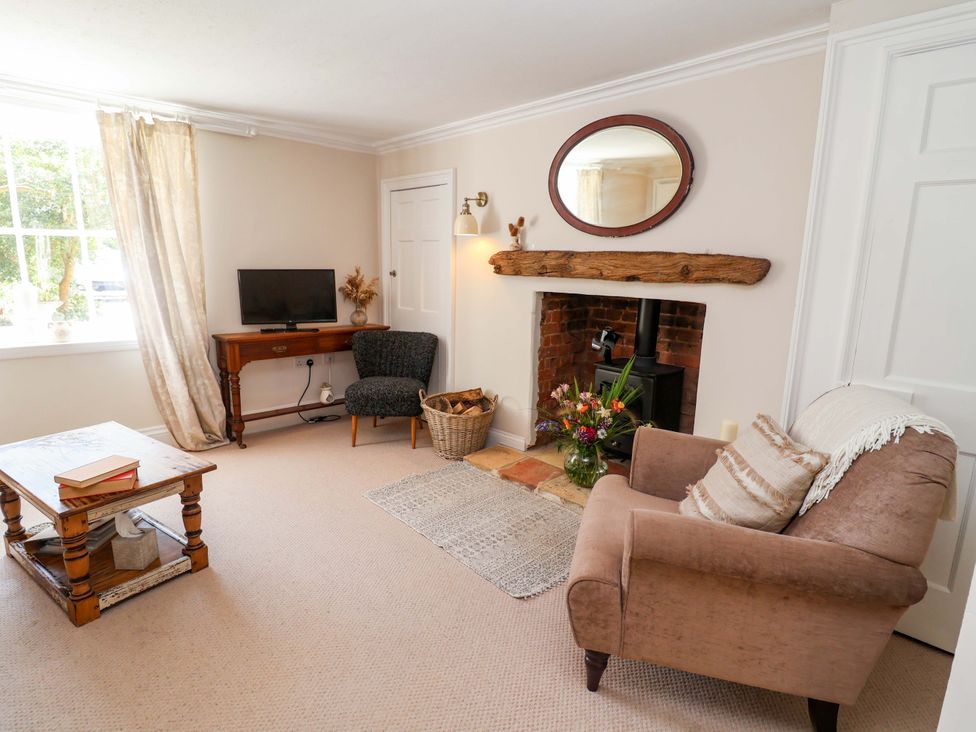 A living room with furniture and a television at Beehive in Beccles