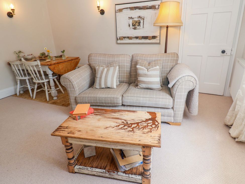 A living room with a sofa and coffee table at Beehive in Beccles